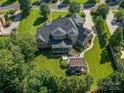 Expansive backyard featuring a hot tub, covered patio and meticulous landscaping at 1377 Shinnecock Ln, Fort Mill, SC 29707