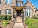 Charming front porch with stone steps and decorative plants at 1377 Shinnecock Ln, Fort Mill, SC 29707