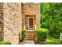 Inviting front entrance with a charming brick staircase and stone accents at 13916 Mallard Lake Rd, Charlotte, NC 28262