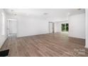 Spacious, naturally lit living room featuring modern flooring and a sliding barn door to the exterior at 157 Fraley Rd, Gastonia, NC 28052