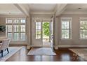 Bright foyer featuring hardwood floors, neutral paint, and an open view to the outdoors at 16016 Reynolds Dr, Fort Mill, SC 29707
