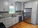 Updated kitchen featuring gray cabinets, stainless steel appliances, and hardwood floors at 1704 16Th Ne St, Hickory, NC 28601