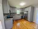 Renovated kitchen with gray cabinets, granite counters, stainless appliances, and hardwood floors at 1704 16Th Ne St, Hickory, NC 28601