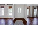 Bright foyer with hardwood floors, a patterned rug, and a view of large windows at 2117 Copperplate Rd, Charlotte, NC 28262