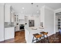 Bright kitchen with white cabinets, stainless steel appliances, and hardwood floors at 2117 Copperplate Rd, Charlotte, NC 28262