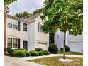 Charming two-story home features a front-entry garage, well-maintained landscaping, and a mature tree in the yard at 2150 Winthrop Chase Dr, Charlotte, NC 28212