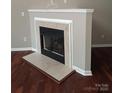 Cozy corner fireplace with marble hearth and a black metal firebox, perfect for relaxing evenings at 2150 Winthrop Chase Dr, Charlotte, NC 28212
