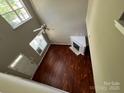 View of the living room showcasing hardwood floors and a cozy fireplace at 2150 Winthrop Chase Dr, Charlotte, NC 28212
