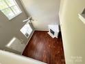An aerial view of the living room showcasing beautiful hardwood floors, fireplace, fan and plenty of natural light at 2150 Winthrop Chase Dr, Charlotte, NC 28212