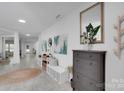 Bright foyer with bench seating, decor, tile floors, and sightlines to other rooms at 2926 Royal Fern Ln, Charlotte, NC 28215