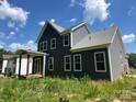Two-story home with gray siding, a covered porch, and large windows offering plenty of natural light at 3218 Player Ct, Salisbury, NC 28144