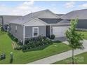 Single-story home with a two-car garage, well-maintained lawn and landscaping at 3317 Black Cherry Dr, Monroe, NC 28110