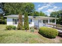 Inviting exterior of a one-story home with well-maintained landscaping and covered porch at 38367 Loblolly Ln, New London, NC 28127
