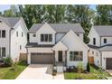Beautiful modern farmhouse with white siding, black trim, and a two-car garage at 3937 Plainview Rd, Charlotte, NC 28208