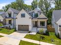 Beautiful, new construction, two-story home featuring a two-car garage, white siding, and manicured lawn at 3945 Plainview Rd, Charlotte, NC 28208