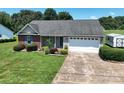 Charming single-story home with a well-manicured lawn, landscaping, and a convenient two-car garage at 402 Beaver Dam Church Rd, Shelby, NC 28152