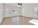 Bright living room showcasing light hardwood floors, a ceiling fan, and white painted walls at 455 Contentment Ct # 18, Kannapolis, NC 28081