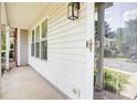 A home entrance featuring a concrete porch, painted rails, and outdoor lighting at 5909 Cougar Ln, Charlotte, NC 28269
