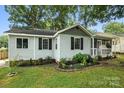 Charming one-story home with fresh landscaping and a cozy, screened front porch at 602 Unity St, Fort Mill, SC 29715