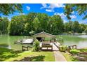 Well-maintained boat dock with a covered area and bench seating at 698 Normandy Rd, Mooresville, NC 28117