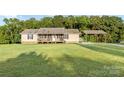 Inviting single-story house with a front porch and covered parking on a large, green lawn at 746 Joe Lentz Rd, Salisbury, NC 28146