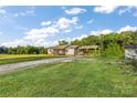 Charming single-story home with a covered parking area surrounded by a well-manicured lawn and trees at 746 Joe Lentz Rd, Salisbury, NC 28146
