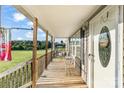 Cozy front porch with wooden railings, a swing, and a 'Welcome to our Home' door decoration at 746 Joe Lentz Rd, Salisbury, NC 28146