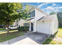 Charming two-story home with a well-manicured lawn, attached garage, and inviting blue door at 7643 Monarch Birch Ln, Charlotte, NC 28215