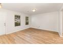 Bright living room featuring hardwood floors, neutral walls, and natural light streaming through two large windows at 7643 Monarch Birch Ln, Charlotte, NC 28215
