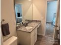 Bathroom with a vanity featuring granite counters, white cabinets, a modern sink and a decorative mirror at 811 Constantine Rd, Richburg, SC 29729