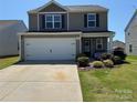 Charming two-story home featuring a well-manicured lawn, a two car garage, and a welcoming front porch at 811 Constantine Rd, Richburg, SC 29729