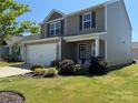 Charming two-story home featuring a well-manicured lawn, a two car garage, and a welcoming front porch at 811 Constantine Rd, Richburg, SC 29729