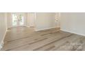 Open living space featuring modern floors, neutral paint and rear French doors at 835 Carrington Dr, Charlotte, NC 28214