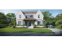 Beautiful white brick home featuring black trimmed windows, manicured landscaping, and a modern design at 914 Edinburgh Ln, Charlotte, NC 28209