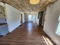 Open living room with wood ceiling, exposed walls, and a view into the kitchen at 1004 S Ridge Ave, Kannapolis, NC 28083