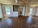 View of a room with wood-look floors, bright windows, and an unfinished fireplace at 1004 S Ridge Ave, Kannapolis, NC 28083