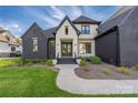 Stunning home entrance with dark brick, light accents, professionally landscaped yard, and a double door at 10119 Laurier Ln, Huntersville, NC 28078
