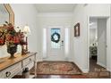 Bright entryway with a decorated glass-paneled door, hardwood floors, and stylish console table at 10120 Berkeley Castle Dr, Charlotte, NC 28273
