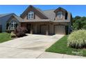 Traditional home with a two car garage and concrete driveway at 1156 Mckee Farm Ln, Belmont, NC 28012