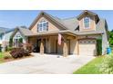 Beautiful home featuring a spacious driveway, attached garage, and covered front porch at 1156 Mckee Farm Ln, Belmont, NC 28012