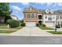 Attractive townhome with a brick facade, two-car garage, and well-manicured front yard at 11724 Easthampton Cir, Charlotte, NC 28277