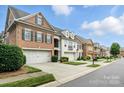 Street view of brick townhouses, garages, and landscaping at 11724 Easthampton Cir, Charlotte, NC 28277