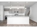 Modern kitchen featuring granite countertops, stainless steel appliances, and stylish gray cabinetry at 1237 Langston Ln, Salisbury, NC 28144