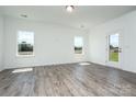 Bright, open-concept living area with hardwood floors, plenty of light, and a modern door at 1237 Langston Ln, Salisbury, NC 28144