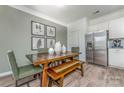 Inviting dining area featuring a wooden table with bench seating and a stainless steel refrigerator at 1248 Langston Ln, Salisbury, NC 28144