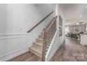 Elegant staircase with carpeted steps, wooden handrail, and decorative iron spindles, leading to the upper level at 1248 Langston Ln, Salisbury, NC 28144