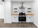 Modern kitchen featuring stainless steel appliances, wood countertops, and floating shelves at 132 Kennedy Ave, Kannapolis, NC 28083