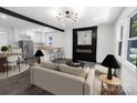 Open-concept living room features a sleek fireplace, modern lighting, and seamless flow to the kitchen at 132 Kennedy Ave, Kannapolis, NC 28083