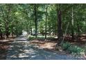 Long driveway leading to home and detached garage surrounded by mature trees at 1325 Lee Lynn Dr # 7 Part Of 6, Albemarle, NC 28001