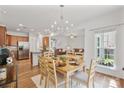 Lovely dining area with wood floors, modern lighting, and stainless steel appliances at 137 Branchview Dr, Mooresville, NC 28115